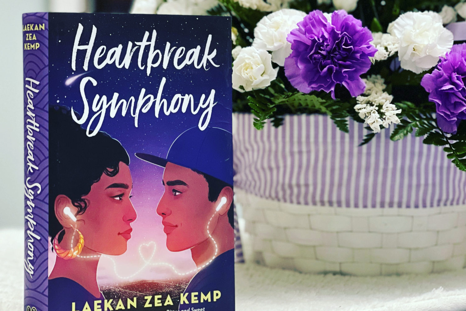 Book cover of Heartbreak Symphony with some flowers